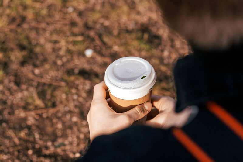A man walking to work with a cup of coffee