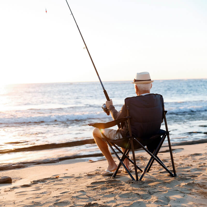 A retired man fishes in the ocean