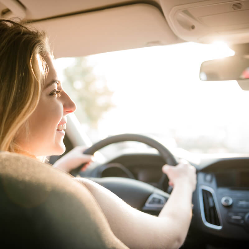 A young woman driving a car