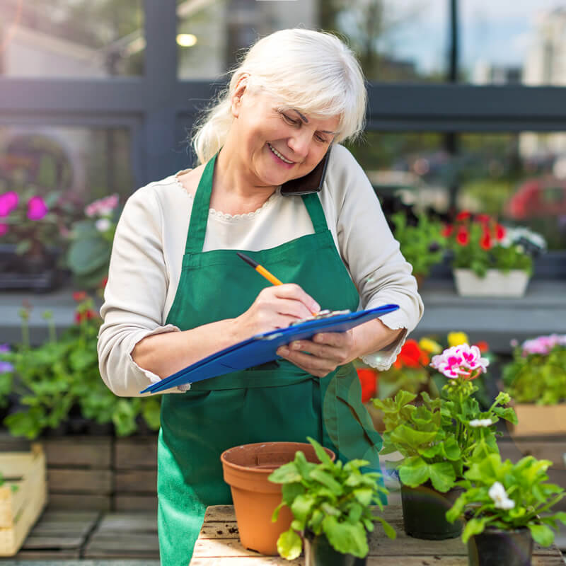 A older woman working in a flower shop