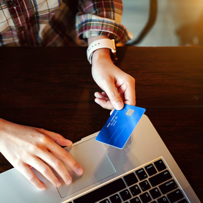 A person makes an online purchase using a credit card.