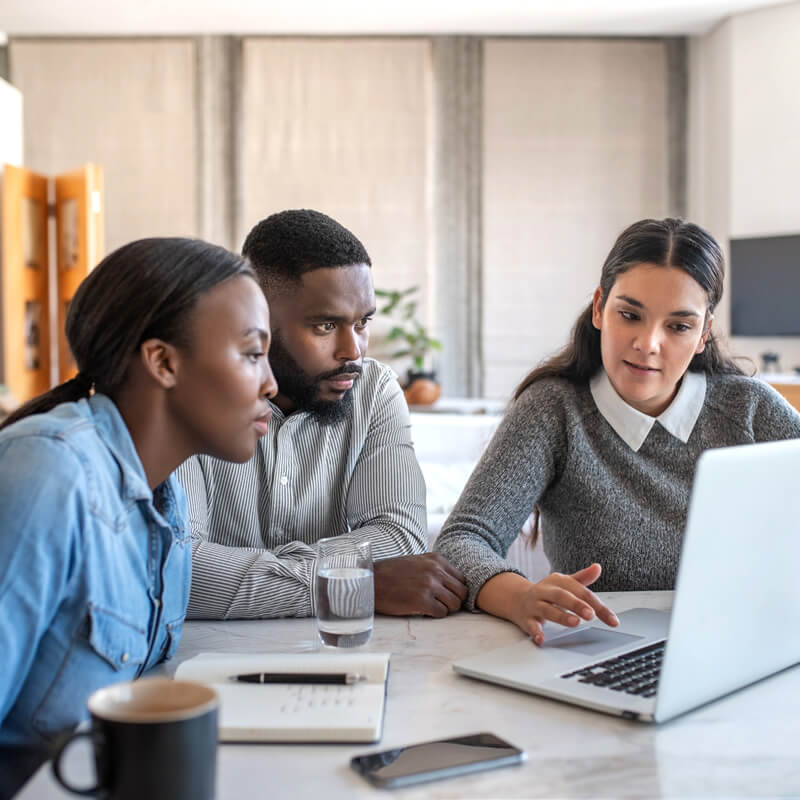 A couple meeting with a financial planner in an office.