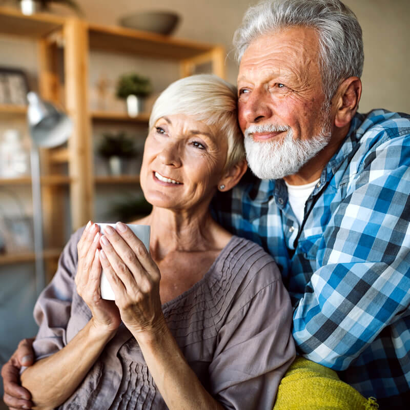 A confident older couple at home.