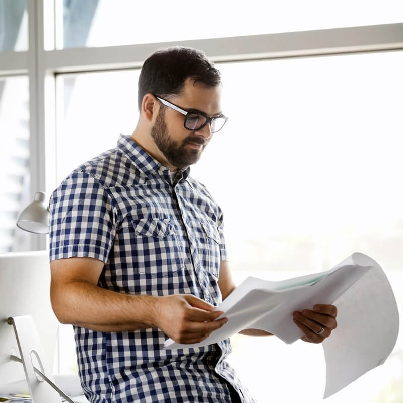 A man reviews documents in the workplace.