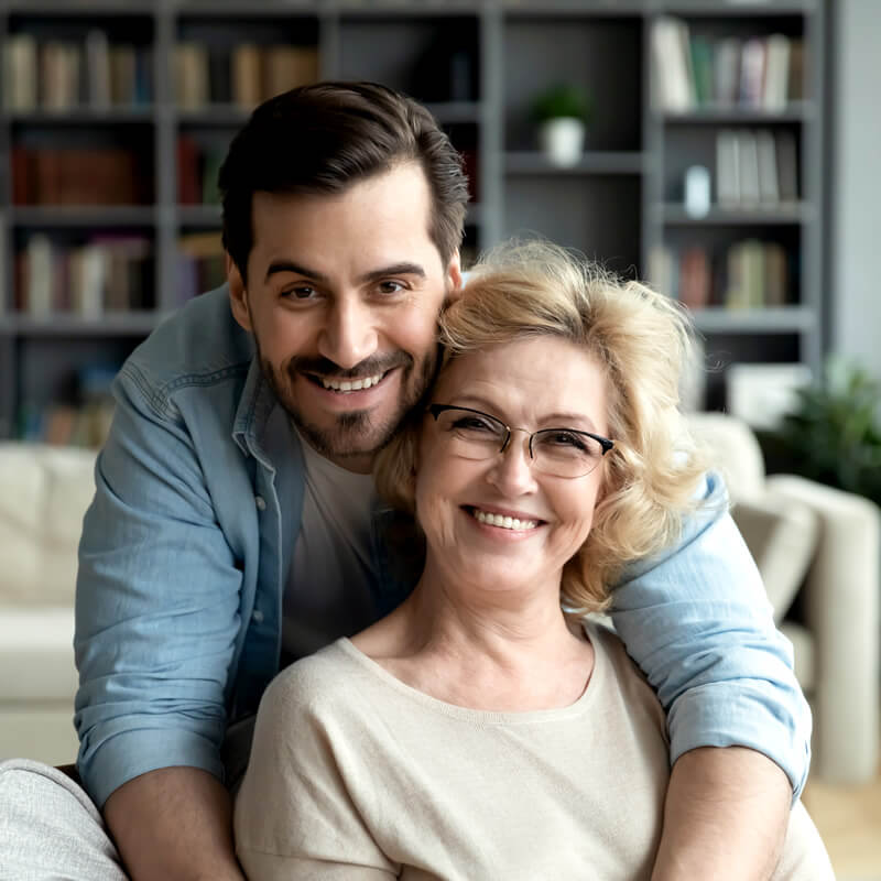 A smiling man with his mother.