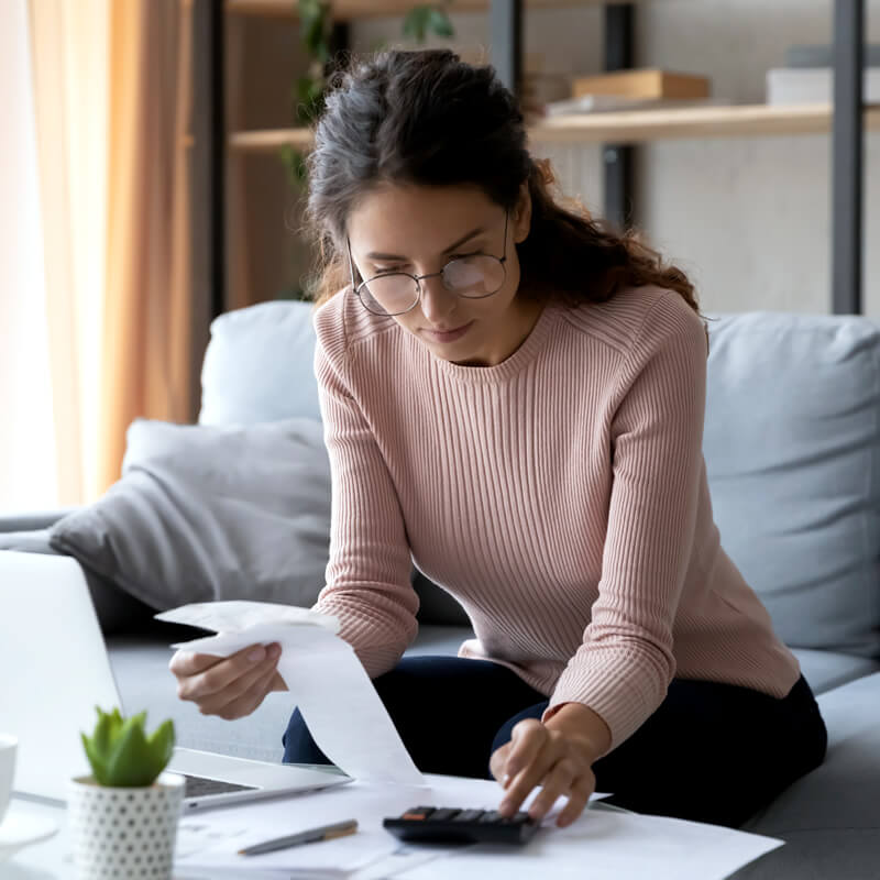 A woman tracking her spending with receipts.