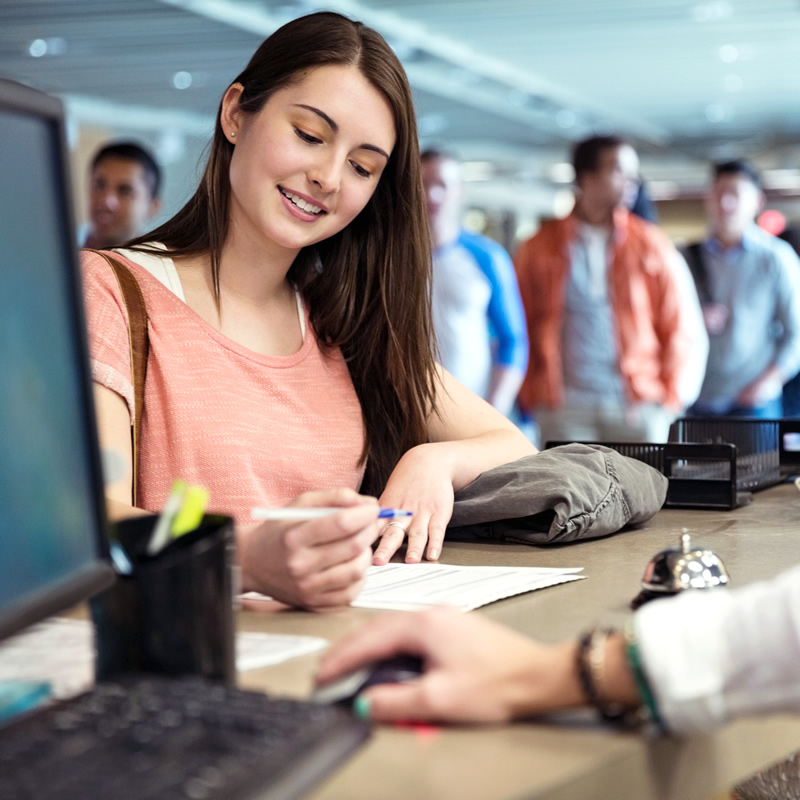 A college student signs a financial aid document at school.
