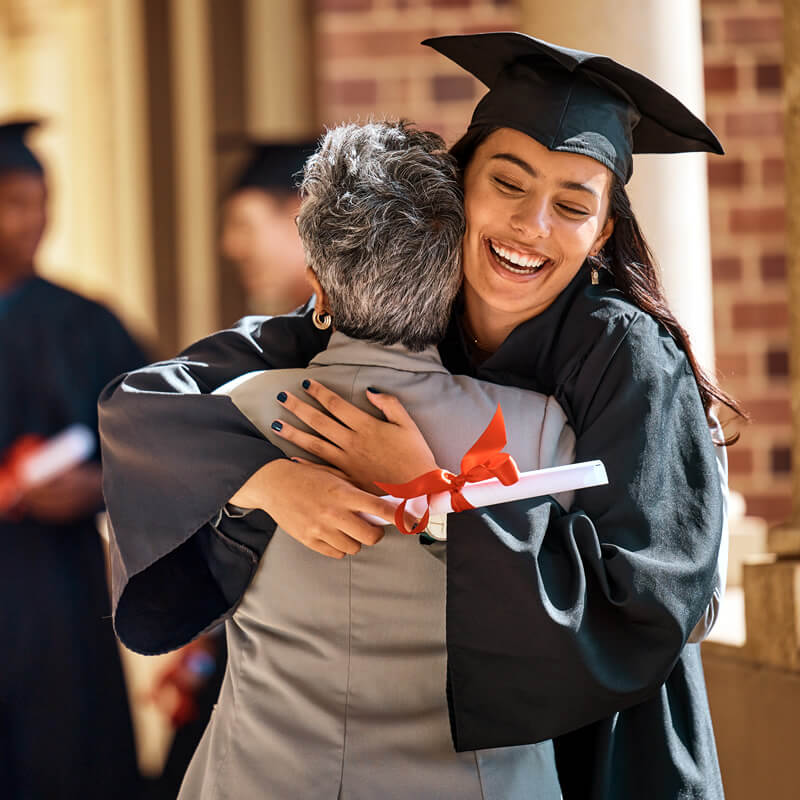 A college graduate hugs her mother