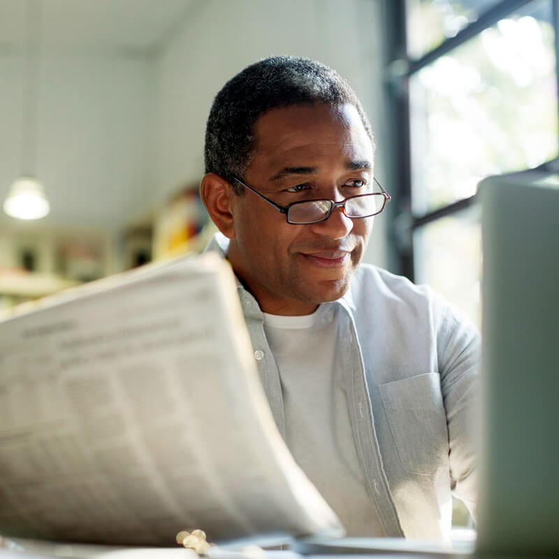A retired man reads the newpaper