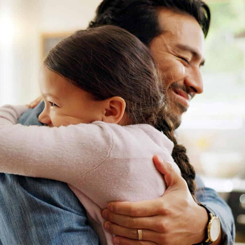 A father hugs his daughter