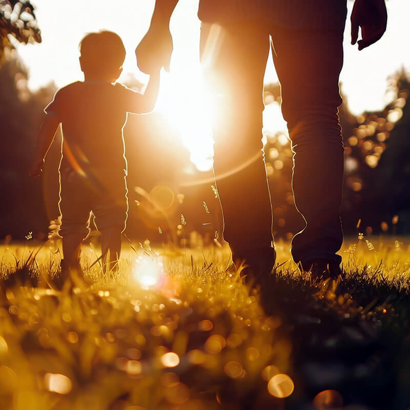 A young child and his father take a walk