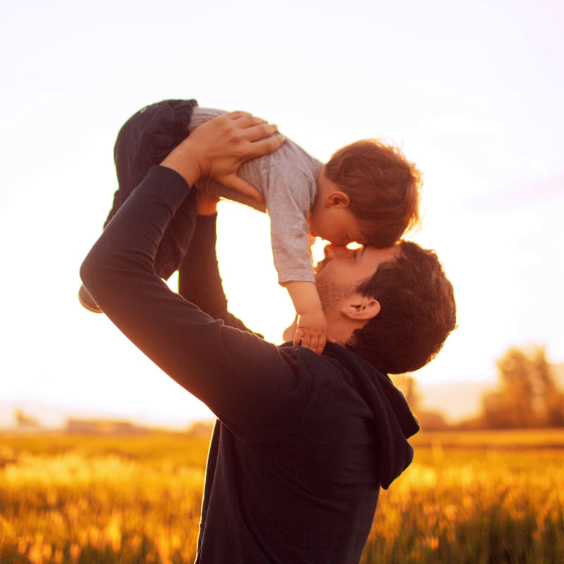 Dad tossing baby in air.