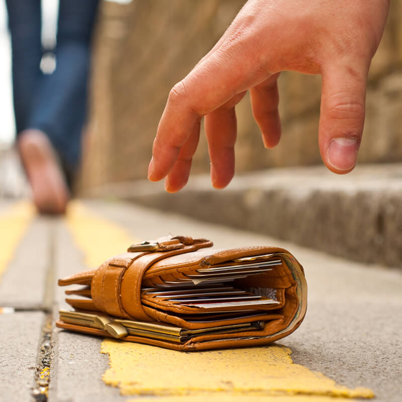 A thief stealing a wallet.