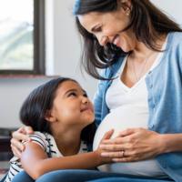 A pregnant mother with her daughter.
