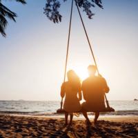 A couple on the beach at sunset.
