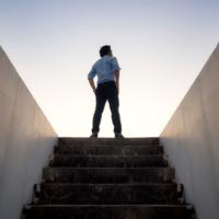 A man at the top of a staircase.