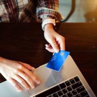 A person makes an online purchase using a credit card.