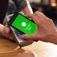 A person make a contactless payment with a smart phone.