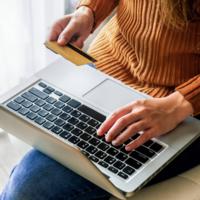 A person makes an online purchase with a credit card.