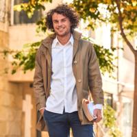 A male college student walking to class.
