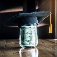 A jar of money with a college cap on top.