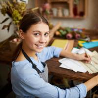 A young business owner paying her bills.