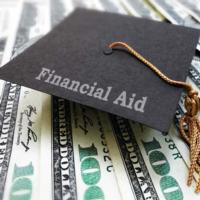 A college cap with the words financial aid written on it.