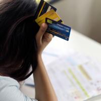 A frustrated woman looking at credit card bills.