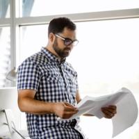 A man reviews documents in the workplace.