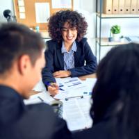 A couple meet with a financial planner in her office.