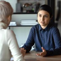 A woman speaks with a financial counselor.