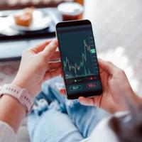 A stock market chart shown on a cell phone screen