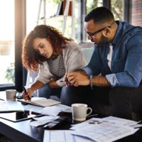 A couple budgeting at home.