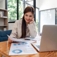 A pleased woman is reviewing her investment results.