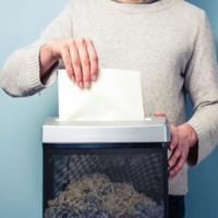 A man shredding a document.