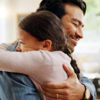 A father hugs his daughter