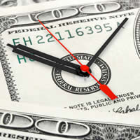 A hundred dollar bill with a clock on its face.