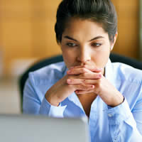 Professional woman looking at computer screen.