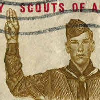 Boy Scout in uniform with hand raised for Scout Pledge. Boy Scouts written above.